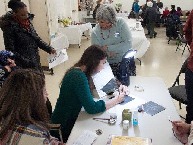 CSO member Rebecca Bruyere demonstrating lettering envelopes at Popup Studio