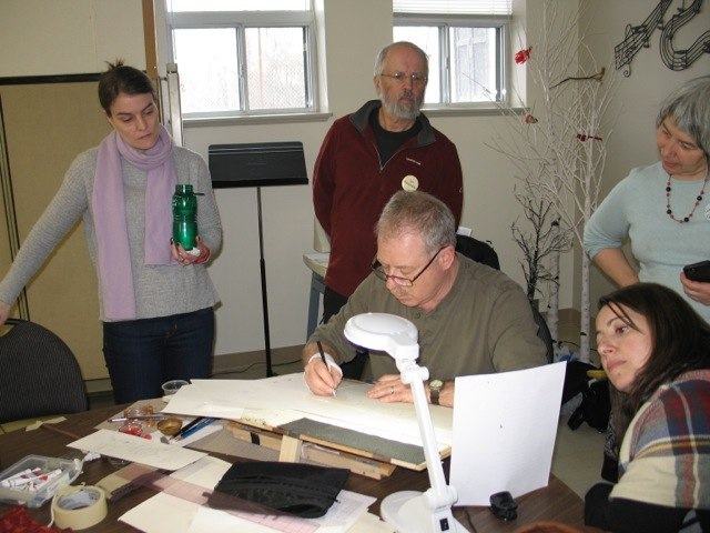 CSO member Rick Draffin demonstrates lettering with a ruling pen at Popup Studio
